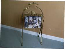 An Edwardian brass magazine rack