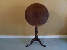 A Georgian oak tilt top tripod table