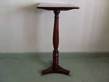 An antique tilt top wine table