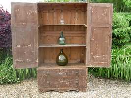 A 19thC painted pine cupboard on chest