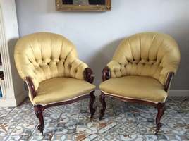 A near pair of upholstered armchairs