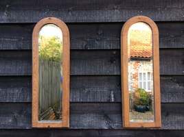 A pair of bleached oak mirrors