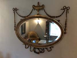 An Adams style oval wall mirror