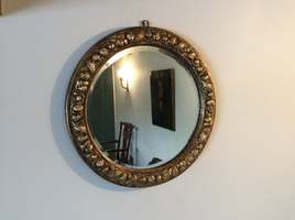 A gilded circular mirror