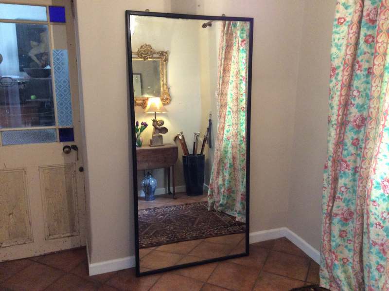 A tall shop fitting or tailors mirror