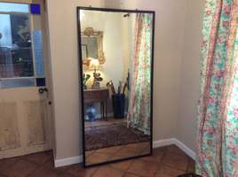 A tall shop fitting or tailors mirror