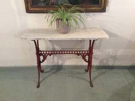 A marble topped cast iron based console table