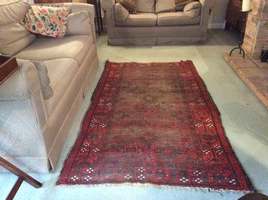A well worn antique rug
